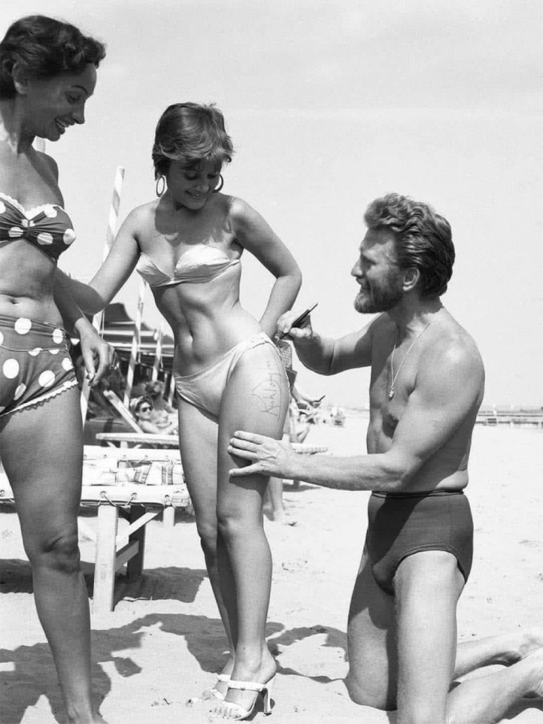 5. Iconic Moment: Kirk Douglas Signing Autographs for Fans on the Beach in 1953