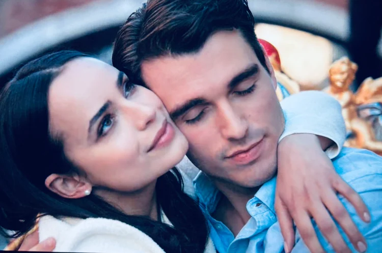 A young American woman standing under Oxford University’s historic archways, holding books and gazing thoughtfully, capturing the romantic and academic setting of My Oxford Year.