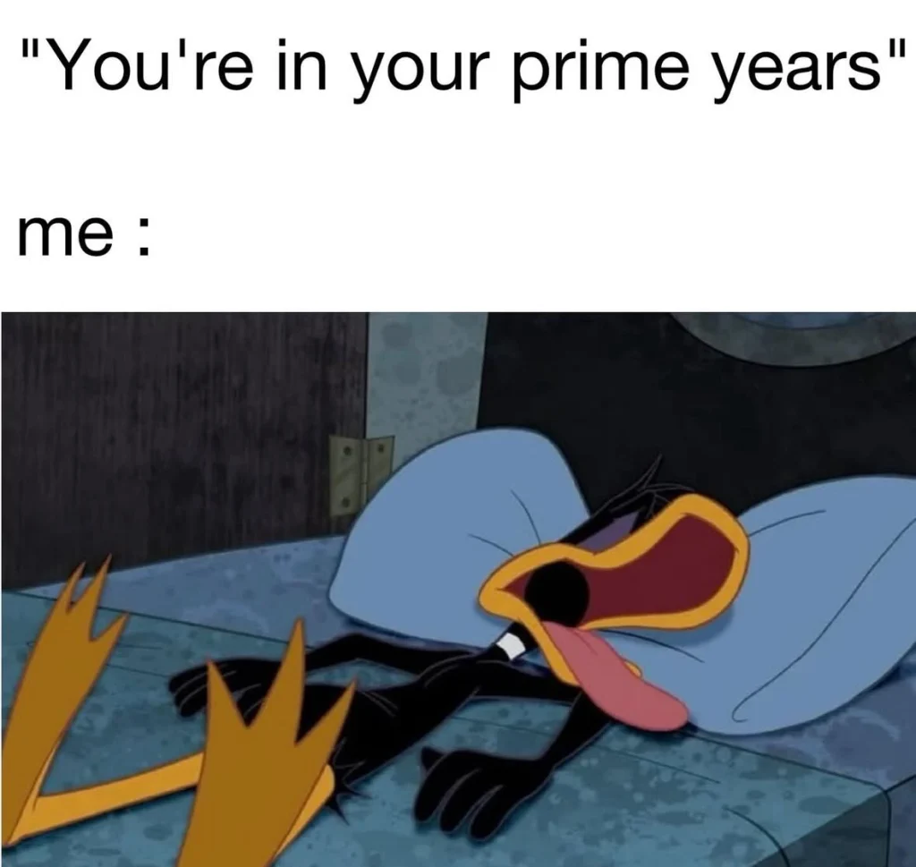 Daffy Duck lying on the floor exhausted with tongue out, reacting to being told he’s in his “prime years.”