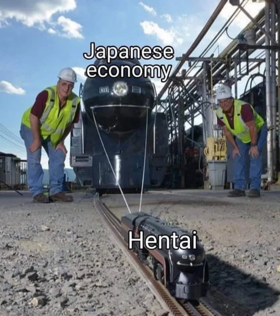 A huge train labeled “Japanese economy” sits on a wide track while a tiny toy train labeled “Hentai” is on a miniature track in front. Two workers in hard hats examine the small train.