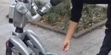 humanoid robot begging China, robot QR code donations, Unitree G1 viral video, humanoid robot cashless payment, robot electricity bills stunt, China street robot performance, viral humanoid robot 2026, robot human interaction, AI marketing stunt, future robotics China