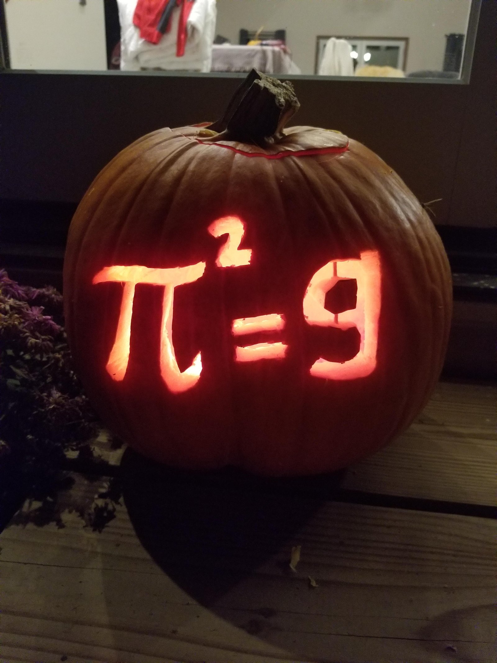 Jack-o-lantern carved with pi squared equals 9 math Halloween meme