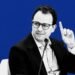 Black and white portrait of Anthropic CEO Dario Amodei raising a finger during a panel discussion, set against a solid bold blue background.