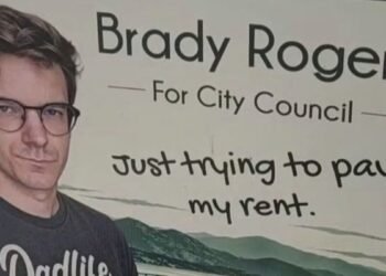 Brady Rogers campaign sign for Kelowna City Council reading “Just trying to pay my rent”
