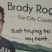 Brady Rogers campaign sign for Kelowna City Council reading “Just trying to pay my rent”