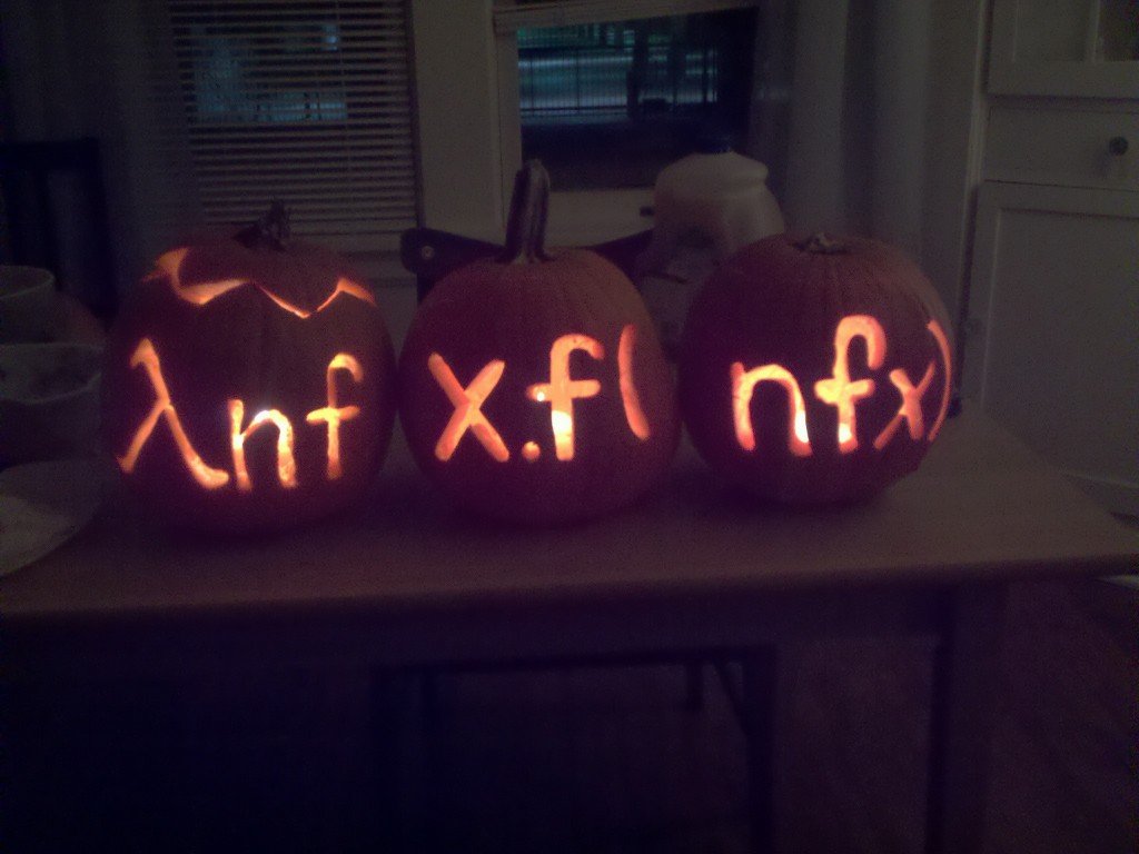 Three pumpkins carved with lambda calculus successor function Halloween programming meme